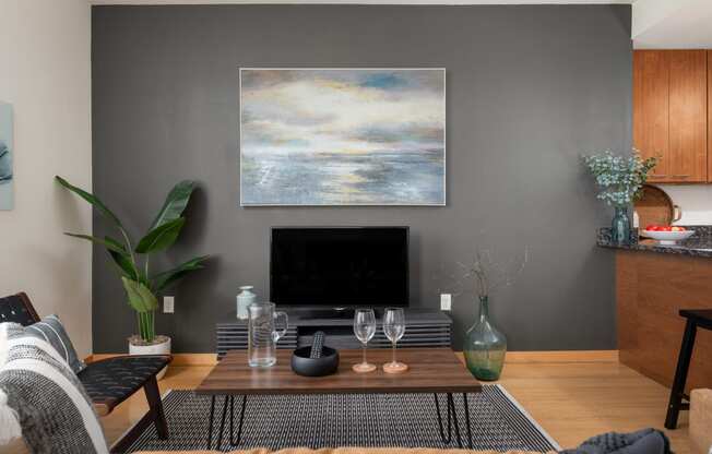 a living room with a coffee table and a television