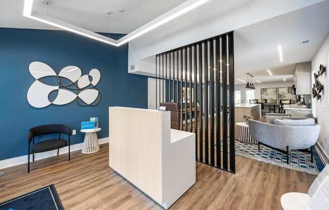 a living room with a blue wall and a white reception desk