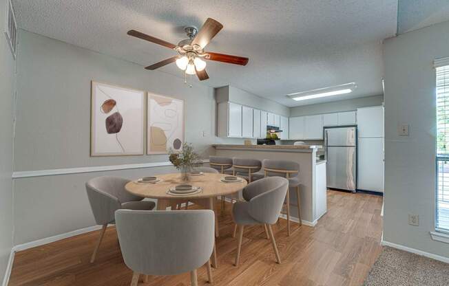 A dining room with a table set for four.