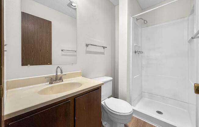 A white sink with a silver faucet is on a countertop.