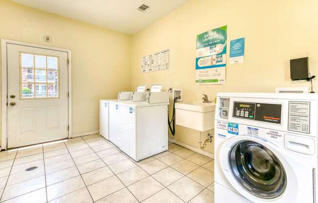 A laundry room with a washer and dryer, a washing machine, and a washing machine.