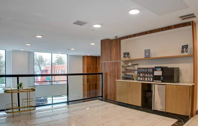 A reception area with a counter and a balcony with a view of the outside.