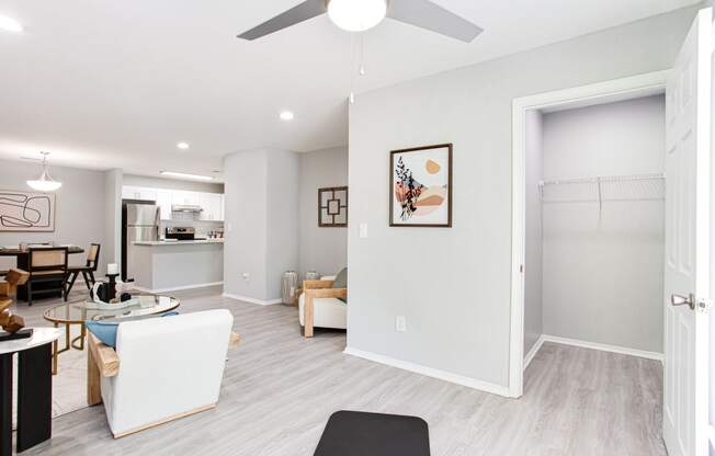 a living room and dining room with a ceiling fan at Parc at 1875, Georgia