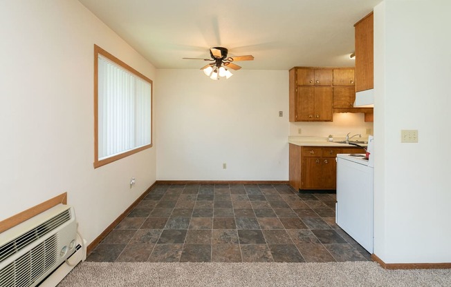 a dining room with a window and ceiling fan. Fargo, ND Islander Apartments