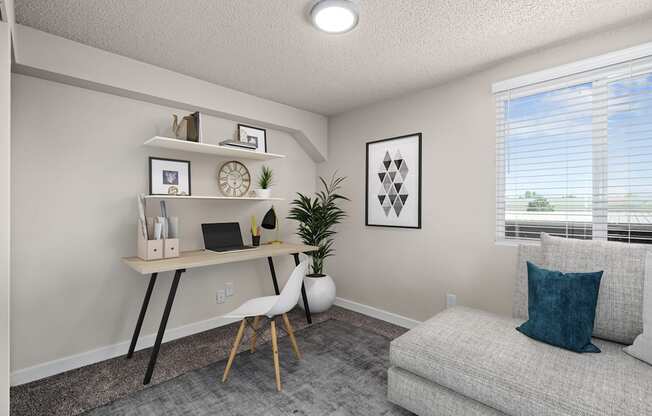 A room with a desk, chair, and a couch.