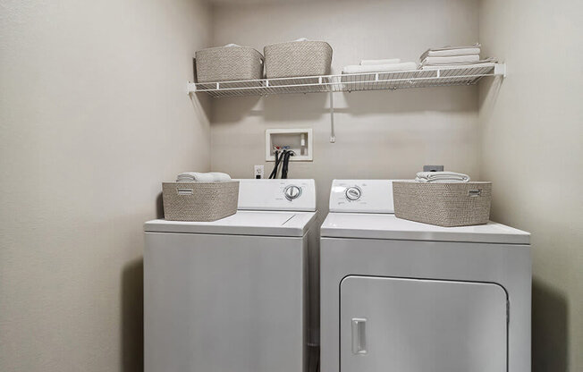 Model Laundry Room with Washer & Dryer at Reserve at Rancho Apartments located in Moreno Valley, CA.