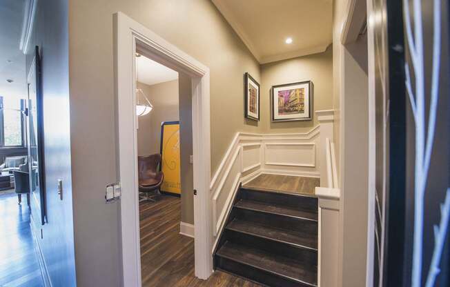 the landing of a staircase in a home with wood floors and white walls at The Knights @ 506 Delaware Apartments, Buffalo, NY 14202