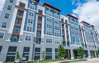 an apartment building with a street in front of it