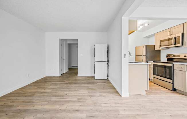 a kitchen with wood floors and white walls