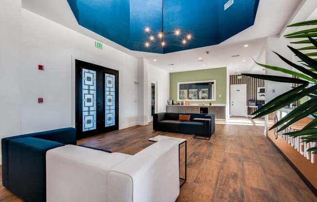 A modern living room with a white sofa and a black and white coffee table.