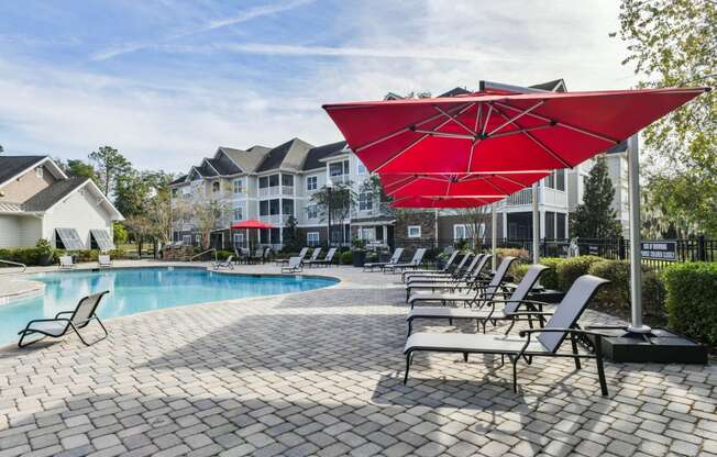 our apartments offer a swimming pool with chairs and umbrellas