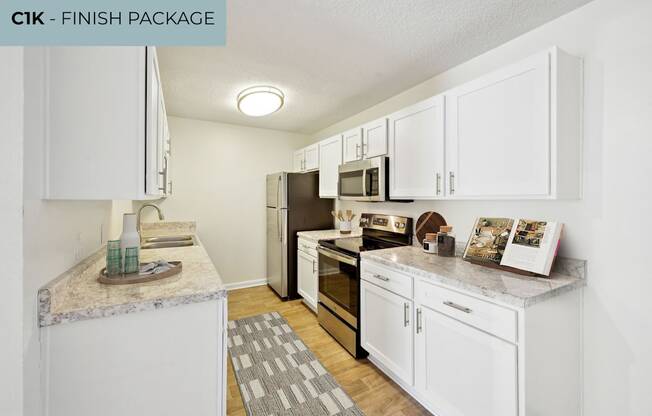 A kitchen with white cabinets and a granite countertop.