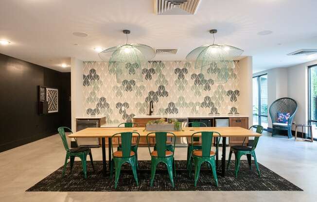 a large dining room with a wooden table and green chairs