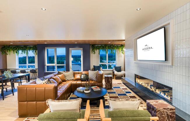 The inviting resident lounge at Modera Beaverton offers cozy seating, scenic views, and modern design for relaxed gatherings.