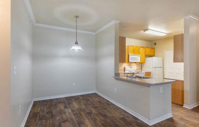 Dining Room with hardwood style flooring, wooden cabinets, and a light fixture