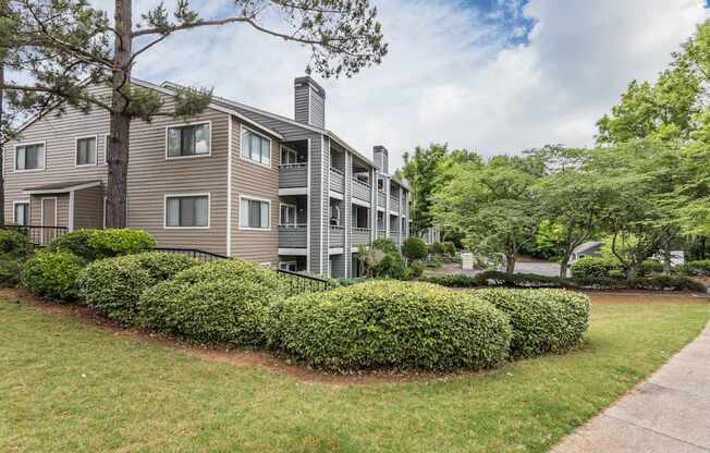 A building with a grey facade and a black fence.