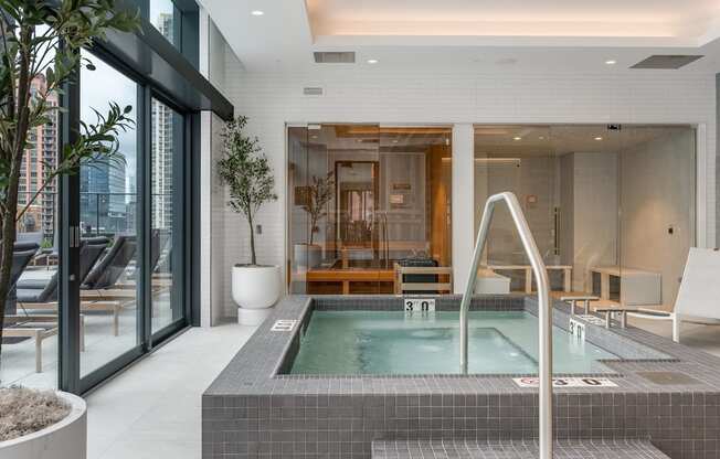 a large jacuzzi pool in the middle of a room with glass doors at Cassidy on Canal, Chicago