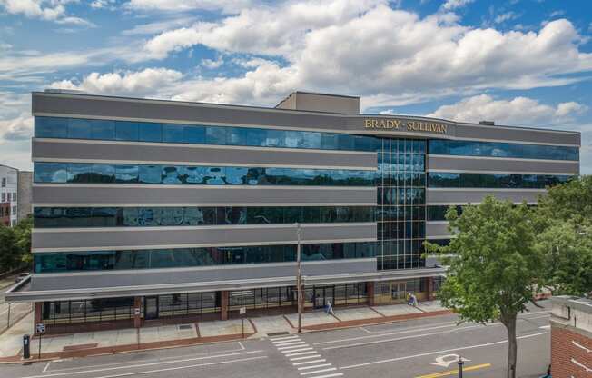 an office building with a glass facade with the words bulding guardian on it