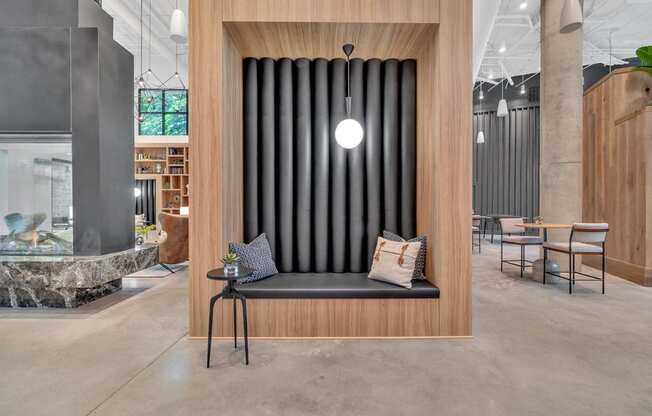 a bench with pillows in a room with a table and chairs