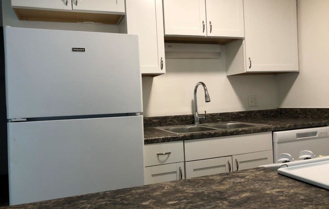 a kitchen with a sink and a refrigerator