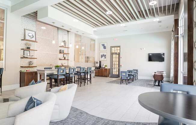 A modern dining room with a long table and chairs.