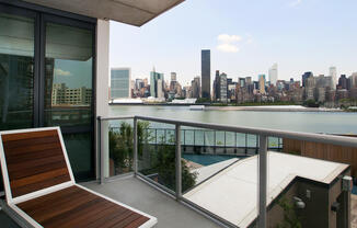 4540 Center Blvd rental with large balcony, view of East River, and Manhattan skyline views. 