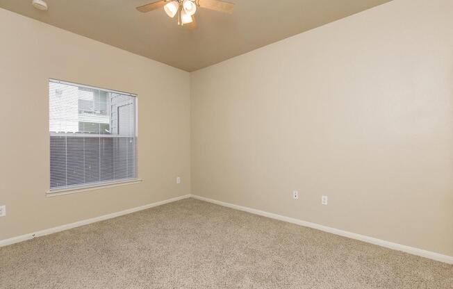 Bedroom with carpeted floors and ceiling fanÂ 