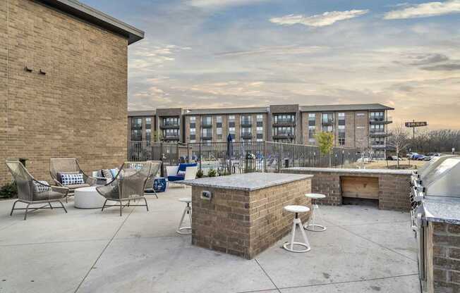 A patio area with a bar and chairs.