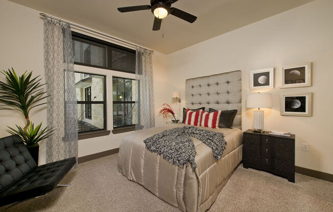 a bedroom with a bed and a ceiling fan