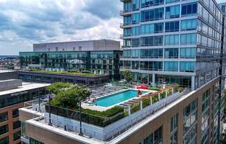 A modern building with a pool on the roof.