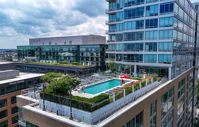 A modern building with a pool on the roof.