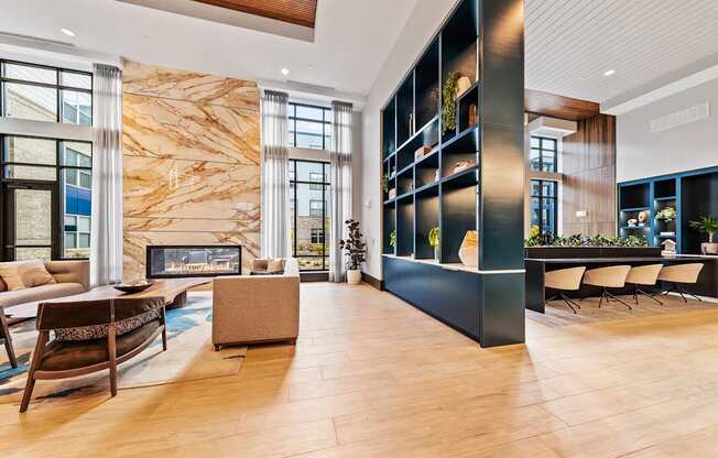 Clubhouse living room with a fireplace and a large marble wall at Preston Ridge Apartments in Cary, NC.