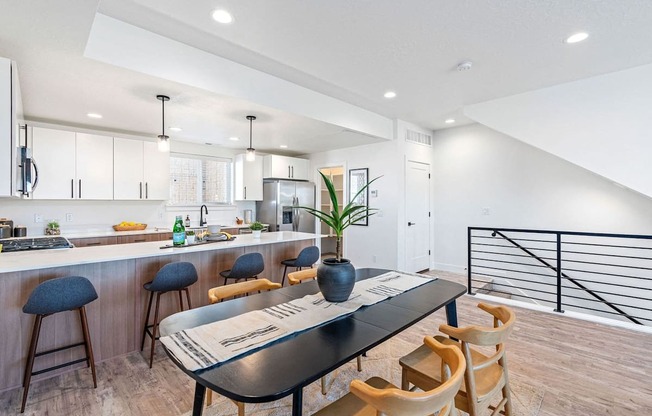 a kitchen and dining room with a table and chairs