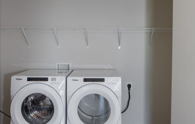 a washer and dryer in a laundry room at Riverhouse Apartments, Fargo, North Dakota 58102