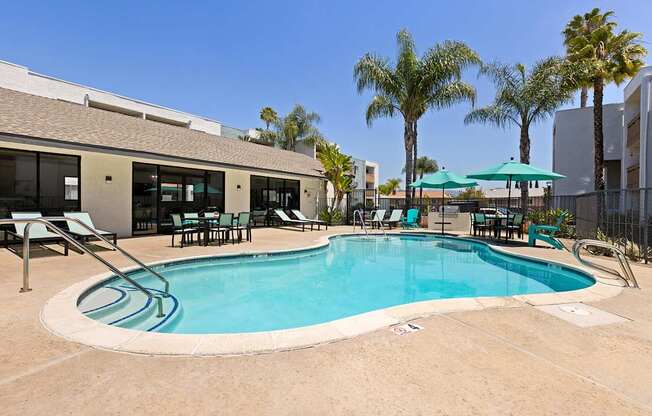 A swimming pool surrounded by chairs and umbrellas.