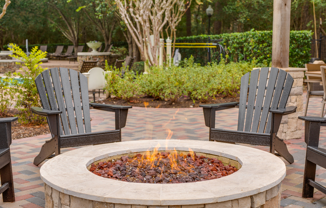 View of Exterior with Fire Pit, Seating Areas, and Landscaping at Raveneaux Apartments