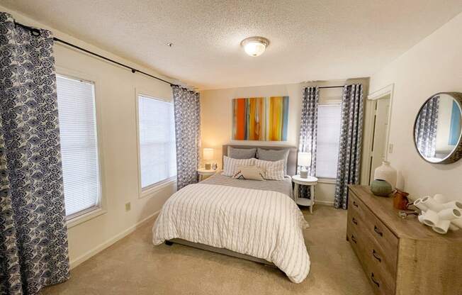 The Crest at Berkeley Lake model apartment bedroom with walk-in closet located in Duluth,GA