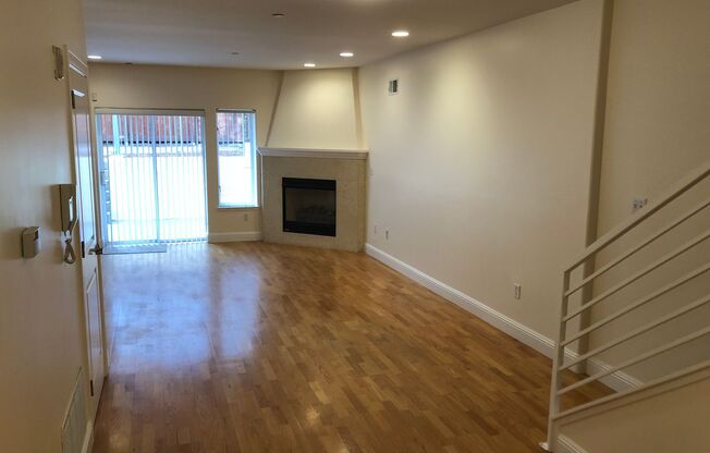 OPEN TOMORROW! Huge bi-level 3 bedroom 2.5 bath loft style apartment w/huge sunny yard, gas fireplace, remodeled kitchen, in-unit laundry and garage parking