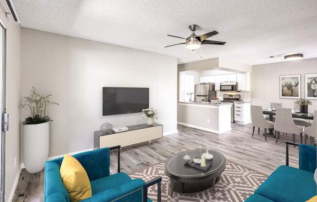 A living room with a blue couch and a television.