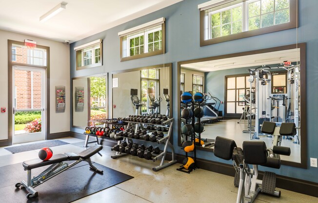 A gym with a variety of equipment including weights and machines.