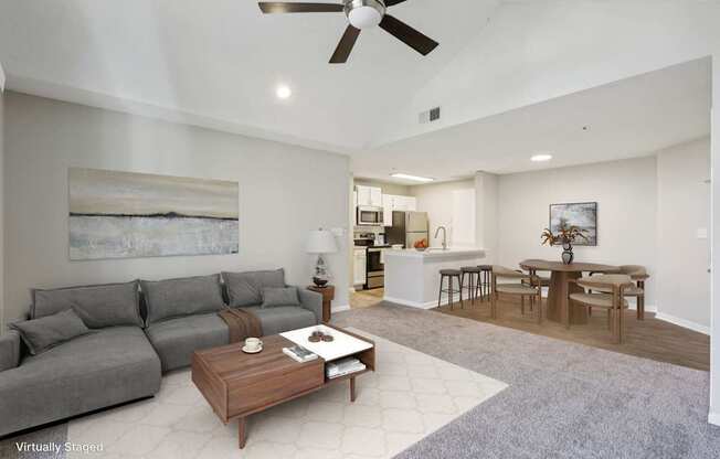 A living room with a grey couch and a coffee table.