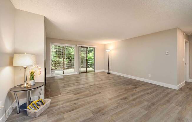 A room with a table and a lamp.