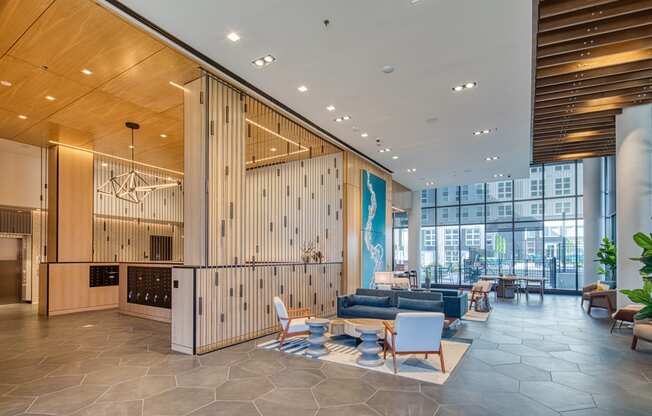 the lobby of a building with a lobby area with couches and chairs