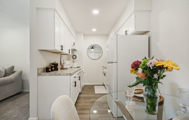 a view of beautiful white kitchen and dining room area