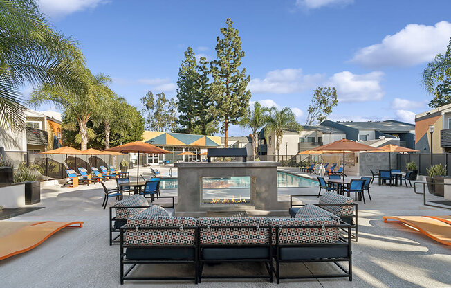 Community Swimming Pool with Pool Furniture at Horizon Apartments located in Santa Ana, CA.