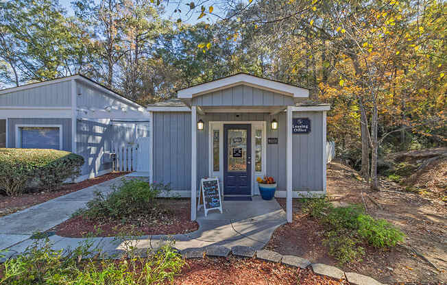 Element at 4411 Macon Apartments A small building with a porch and a sign in front of it.