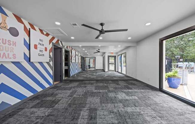 A hallway with a blue and white striped wall and a sign that says "rush to our goals".
