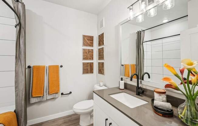Furnished bathroom with quartz countertop in model apartment
