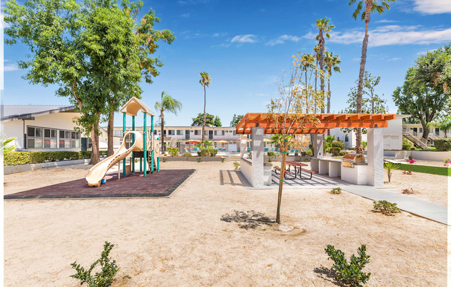 A playground with a slide, swings, and a picnic table.