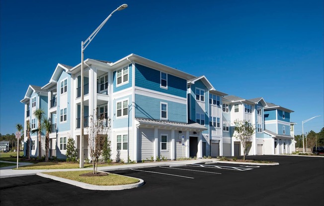 A row of modern townhouses with blue and white exterior.